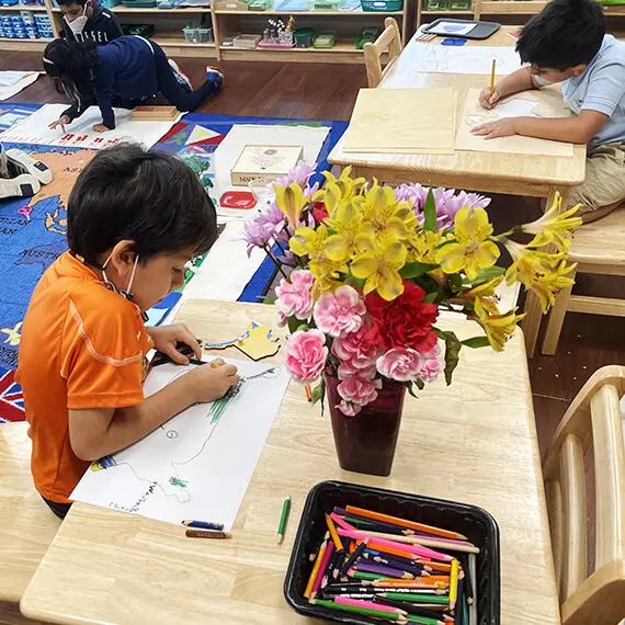 Children drawing in the book