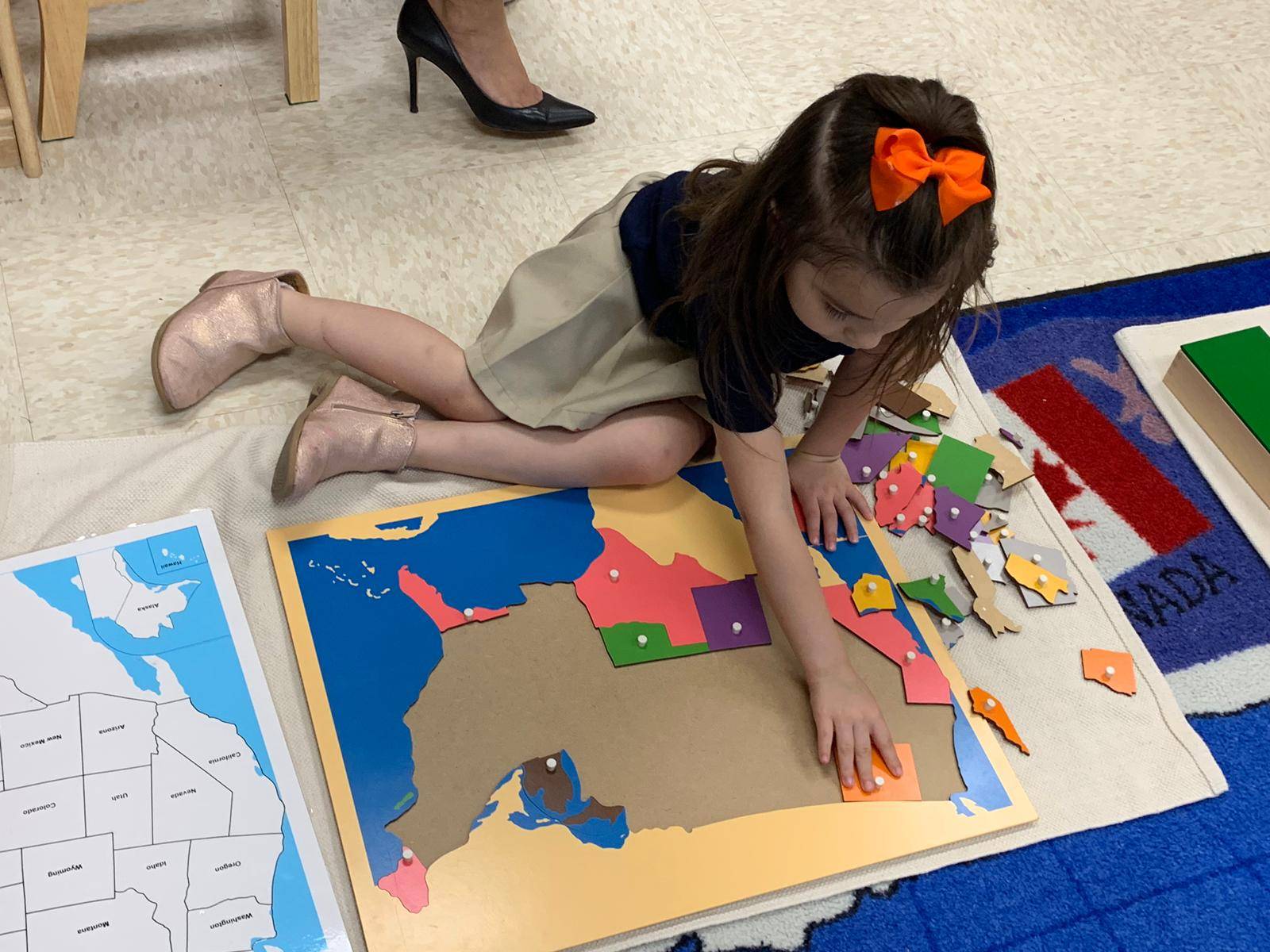 Small girl playing with puzzle